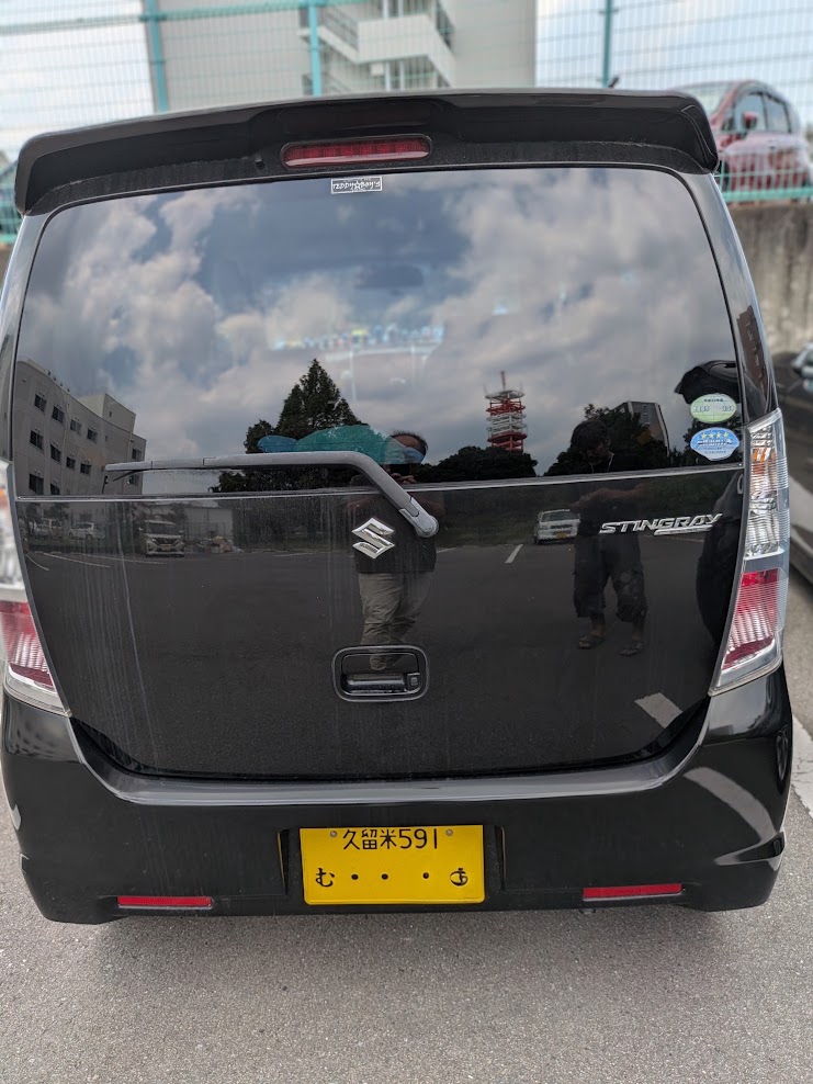 Rear view of a black Suzuki Stingray minivan with a yellow Japanese license plate in a parking lot. - 車専門鍵店カーロック 施工実績・鍵作成